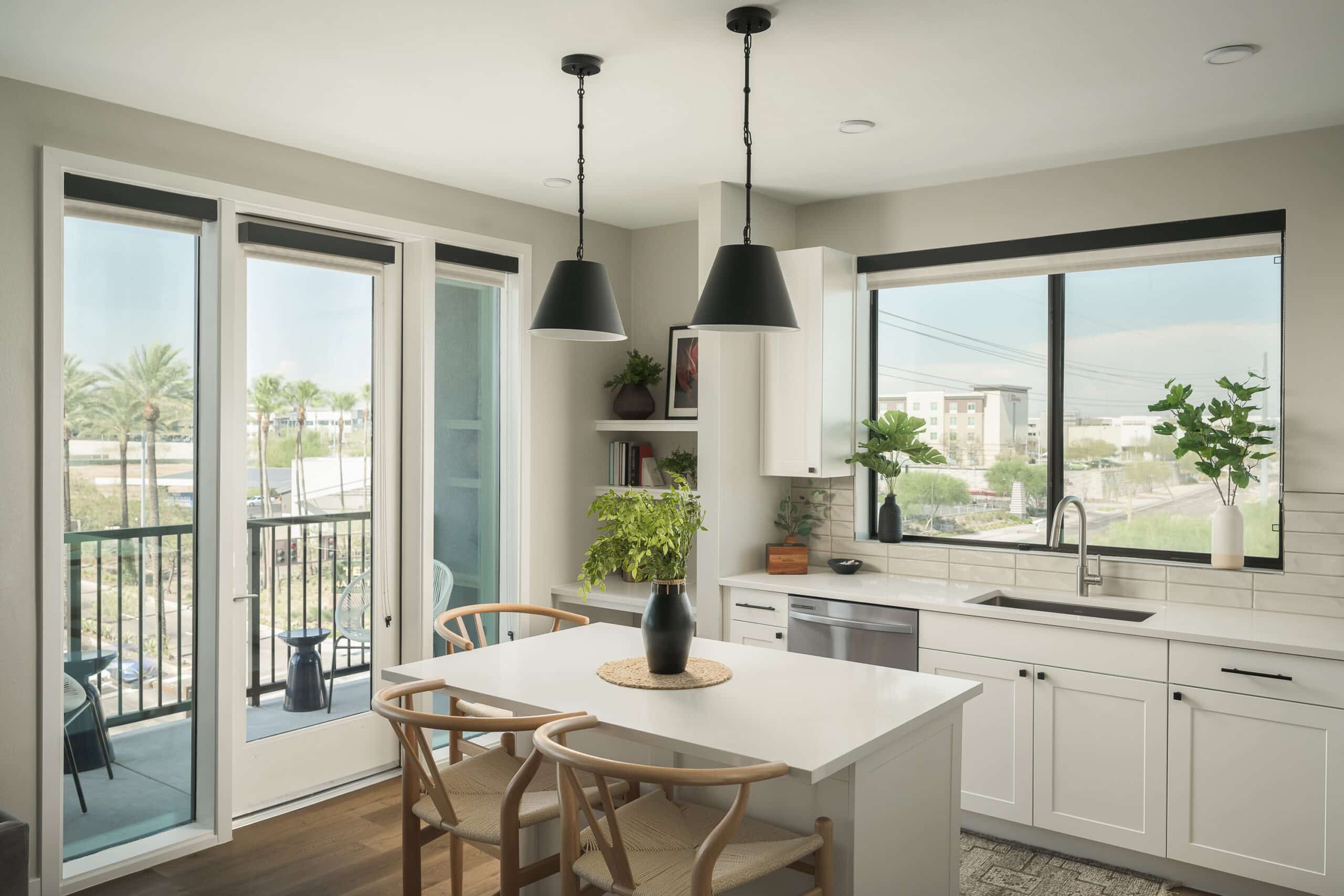 Modern kitchen interior with dining area and balcony access.