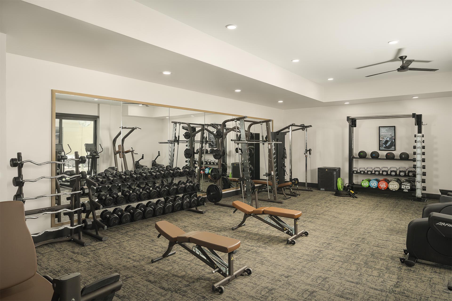 Smith & Rio fitness center with a variety of strength training equipment, including dumbbells, benches, and resistance machines.