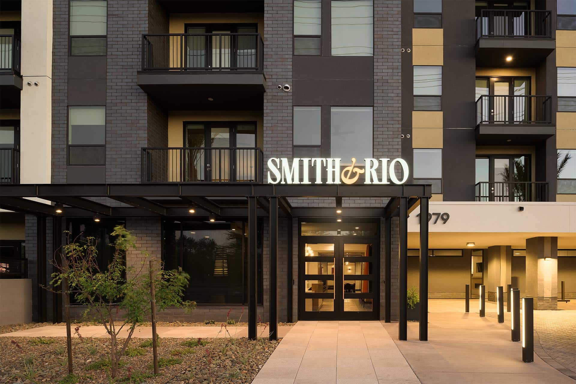 Apartment building entrance with "smith & rio" signage.
